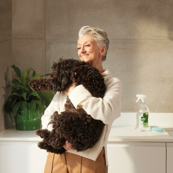 Reckitt- woman holding a dog with dettol in the background