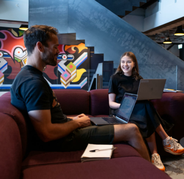 Man and woman working on sofa