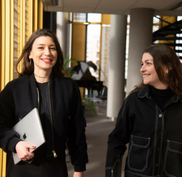 Two women walking in a corridor