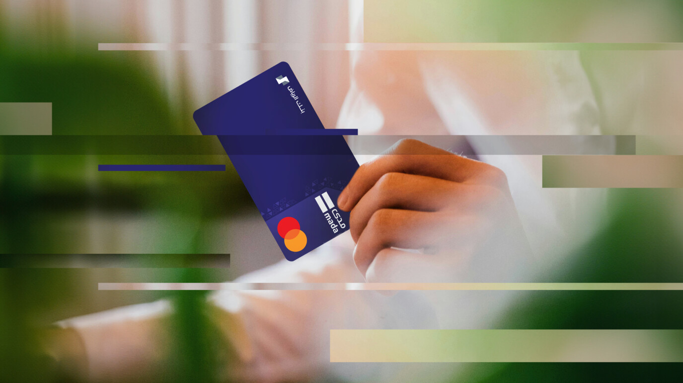 Pixelated image of hand holding bank card